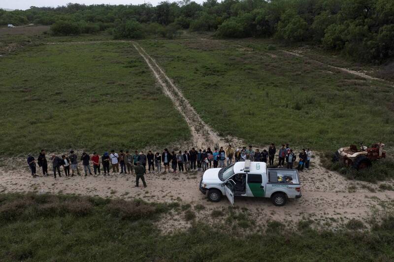 大批來自中国的非法移民企圖闖進美國邊境，被美國邊境巡邏隊逮捕。（路透）