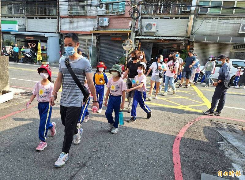 霧峰吉峰國小今天舉辦健行和感恩親子活動，吸引數百位家長參加，牽著孩子的手一起健行。（記者陳建志攝）