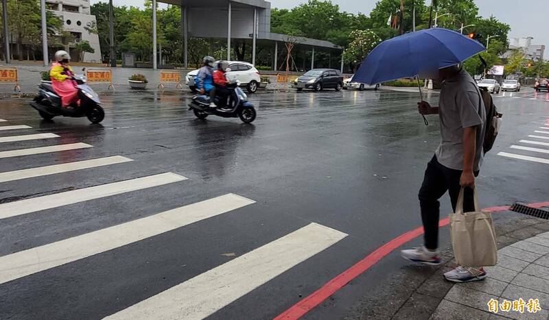 高雄今受鋒面影響降雨，市區也下雨了。（記者陳文嬋攝）