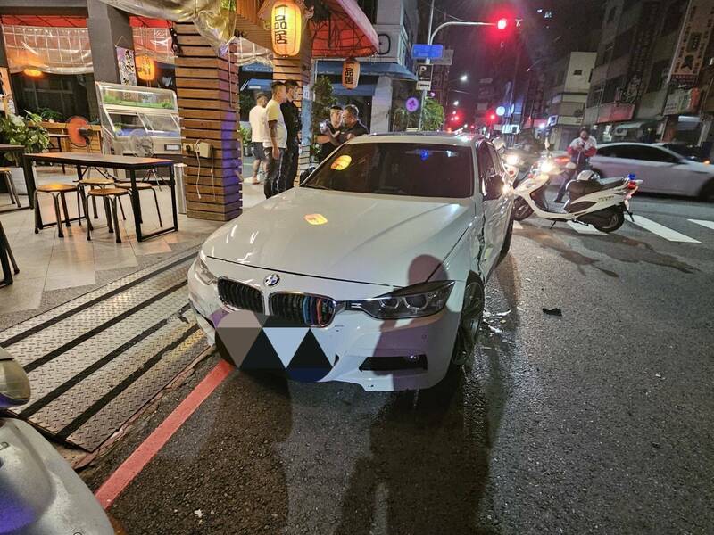 1輛停在熱炒店前的BMW轎車遭人持棍棒砸車，造成車輛鈑金、車窗等多處毀損。（民眾提供）