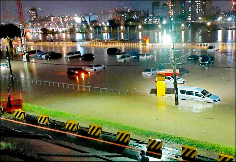 台北市去年10月因尼莎颱風外圍環流導致暴雨成災，堤外百輛車慘泡水。（資料照）