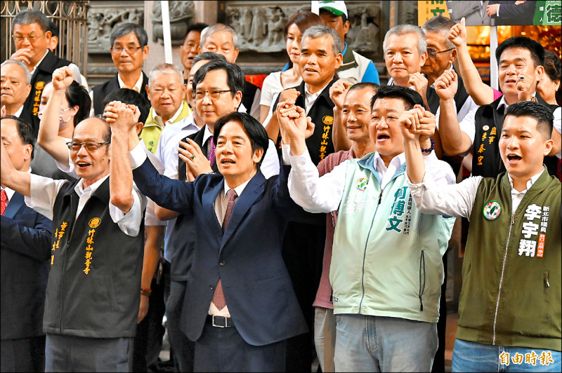 民進黨總統參選人賴清德（前排右三）昨至林口竹林山觀音寺參香，與廟方董監事合影喊凍蒜。（記者塗建榮攝）