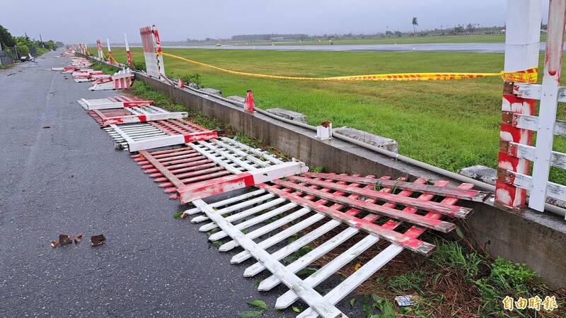 台東機場跑道旁的柵欄成排倒塌。（記者黃明堂攝）