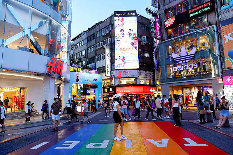 
A woman poses for photos at Ximending shopping district in Taipei on July 25.
Photo: Ann Wang, Reuters