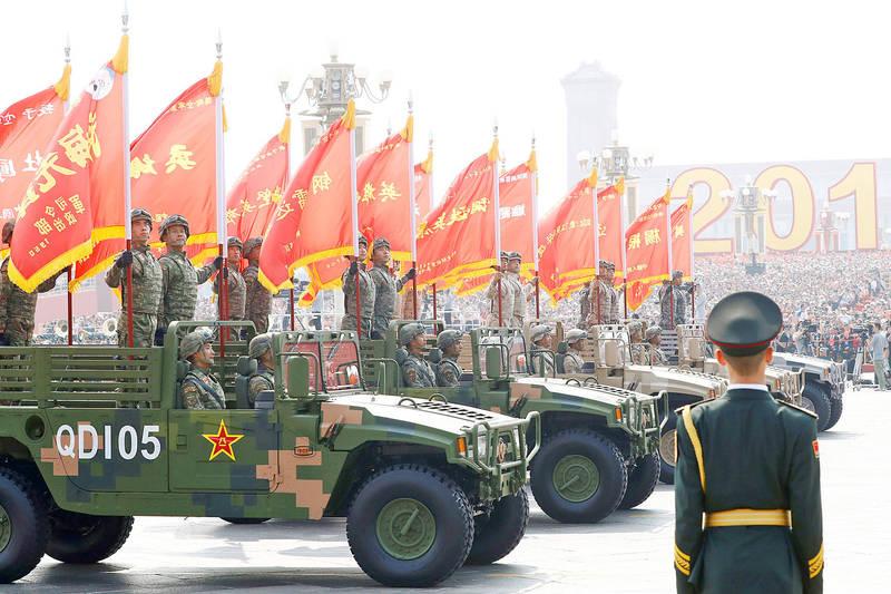 
Soldiers in military vehicles participate in a military parade marking the 70th anniversary of the founding of the People’s Republic of China in Beijing on Oct. 1, 2019.
Photo: Reuters