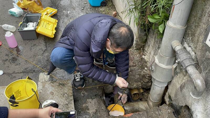 環保局稽查人員現場採取紡織廠排放水檢測。（新北市環保局提供）