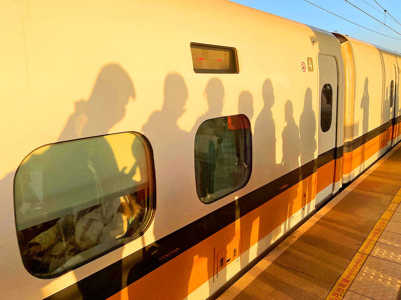 Passengers’ shadows are cast on a high-speed rail train car in Tainan on Wednesday last week.
Photo: CNA
Passengers’ shadows are cast on a high-speed rail train car in Tainan on Wednesday last week.
Photo: CNA