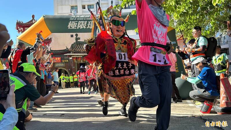 選手們扛著5公斤重的三太子神偶,在鳴嗆後起跑,邁入第7天的徒步行程。(記者許麗娟攝) 選手們扛著5公斤重的三太子神偶,在鳴嗆後起跑,邁入第7天的徒步行程。(記者許麗娟攝)