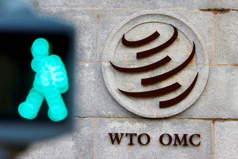 
A crosswalk light blinks in front of the WTO logo at its headquarters in Geneva, Switzerland, on Oct. 28, 2020.
Photo: Reuters