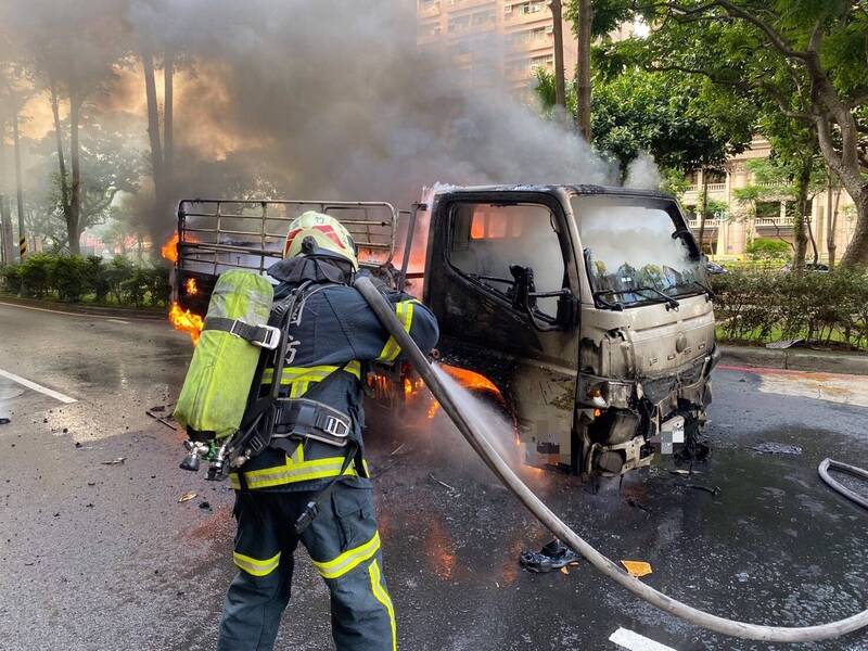 消防隊員緊急撲滅搬家公司貨車的火勢。（桃園市政府提供）