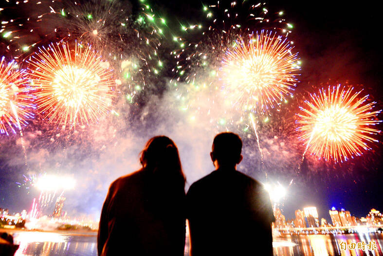 
A couple watches a firework display during the Taipei Dadaocheng Fireworks Festival and Lovers’ Day celebration in an undated photograph.
Photo: Wang Yi-sung, Taipei Times