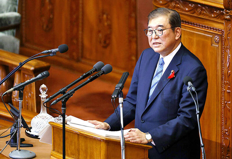 Japanese Prime Minister Shigeru Ishiba delivers a speech at the parliament in Tokyo yesterday.
Photo: EPA-EFE