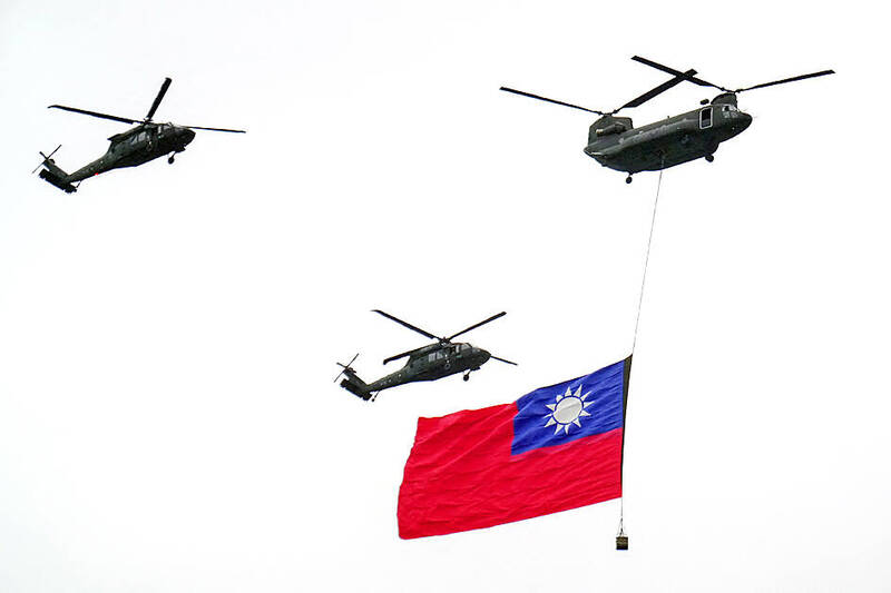 A Taiwanese army CH-47 Chinook, top R, and UH-60 Black Hawk helicopters fly in formation with the Taiwanese flag during National Day celebrations in front of the Presidential Office in Taipei on October 10.
Photo: Walid Berrazeg, AFP