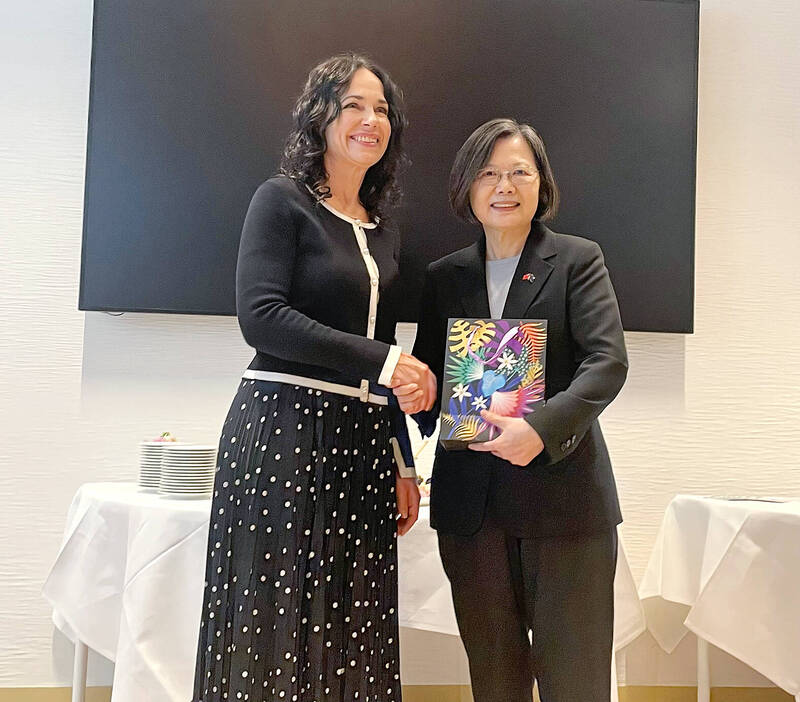 Slovakian Member of the European Parliament Miriam Lexmann, left, and former president Tsai Ing-wen shake hands at an event in Brussels on Thursday.
Photo: CNA