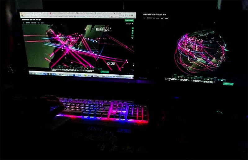 
A member of the hacking group Red Hacker Alliance accesses a Web site that monitors global cyberattacks at their office in Dongguan, China, on Aug. 4, 2020.
Photo: AFP