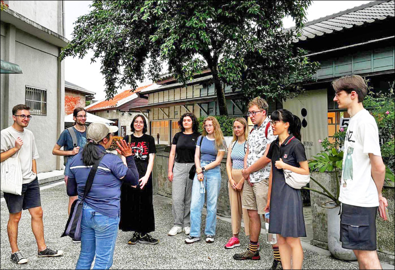 大溪文化觀光產業推展協會理事長黃淑君（前左），帶外國遊客導覽木博館。（黃淑君提供）