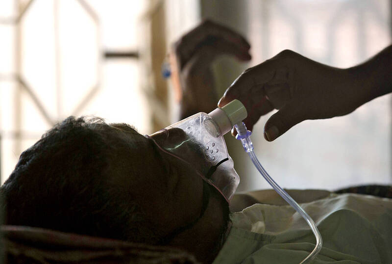 
A person adjusts the oxygen mask of a tuberculosis patient at a hospital in Hyderabad, India, on March 24, 2018.
Photo: AP