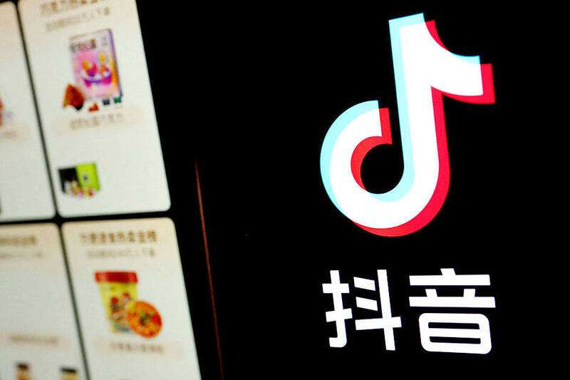 
The Douyin logo is pictured next to a mobile phone displaying an e-commerce site on the app in an arranged photograph taken on Oct. 25 last year.
Photo: Reuters