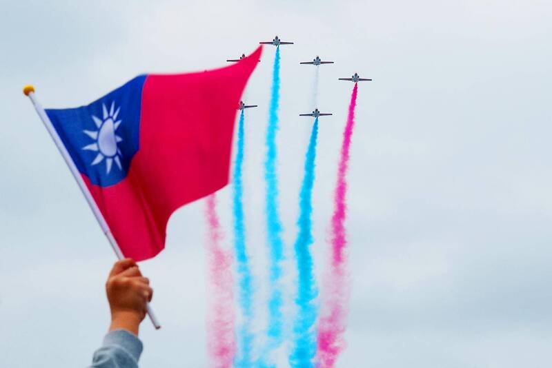 A Taiwanese flag is seen as Taiwanese air force Thunder Tiger Aerobatics Team jets fly by during Taiwan’s 113th National Day celebrations in Taipei on Oct. 10.
Photo: AFP