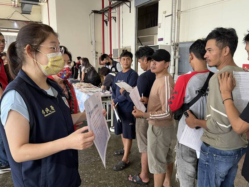 移民署人員藉著舉行發放物資及義剪活動時，進行政令宣導。（記者吳昇儒翻攝）