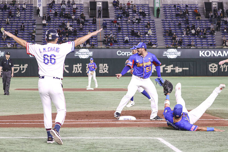 Taiwan coach Chang Chien-ming, left, and Venezuela pitcher Nivaldo Rodriguez, center, react after a play at first base during their Premier12 Super Round game at the Tokyo Dome yesterday.
Photo: CNA