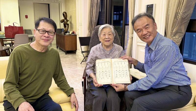 苓洲國小120年校慶前夕，校長吳國泰（右）邀請100歲高齡校友孫陳錦境（中）返校傳承聖火，並翻閱有寫著她名字的手抄本畢業名冊，圖左為孫陳錦境的兒子孫國棟醫師。（苓洲國小提供）