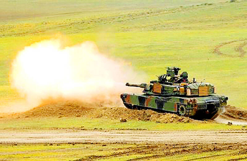 
An Abrams M1A2 tank fires a shell from a firing range emplacement in an undated photograph.
Photo: Reuters