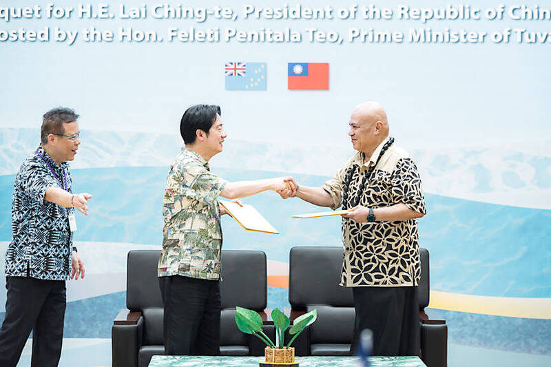 
President William Lai, center, shakes hands with Tuvaluan Prime Minister Feleti Teo in Funafuti yesterday.
Photo courtesy of the Taiwan Presidential Office