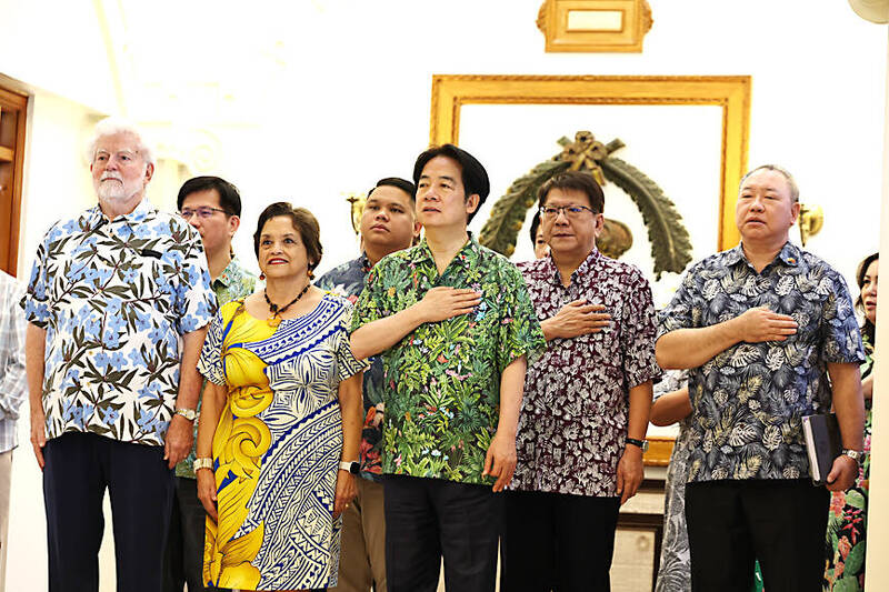 President William Lai, center, sings the Republic of China national anthem in Guam yesterday beside Guam Governor Lourdes Leon Guerrero, second left.
Photo: CNA