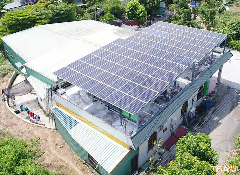 
Solar panels are pictured on a roof in an undated photograph.
Photo: Taipei Times