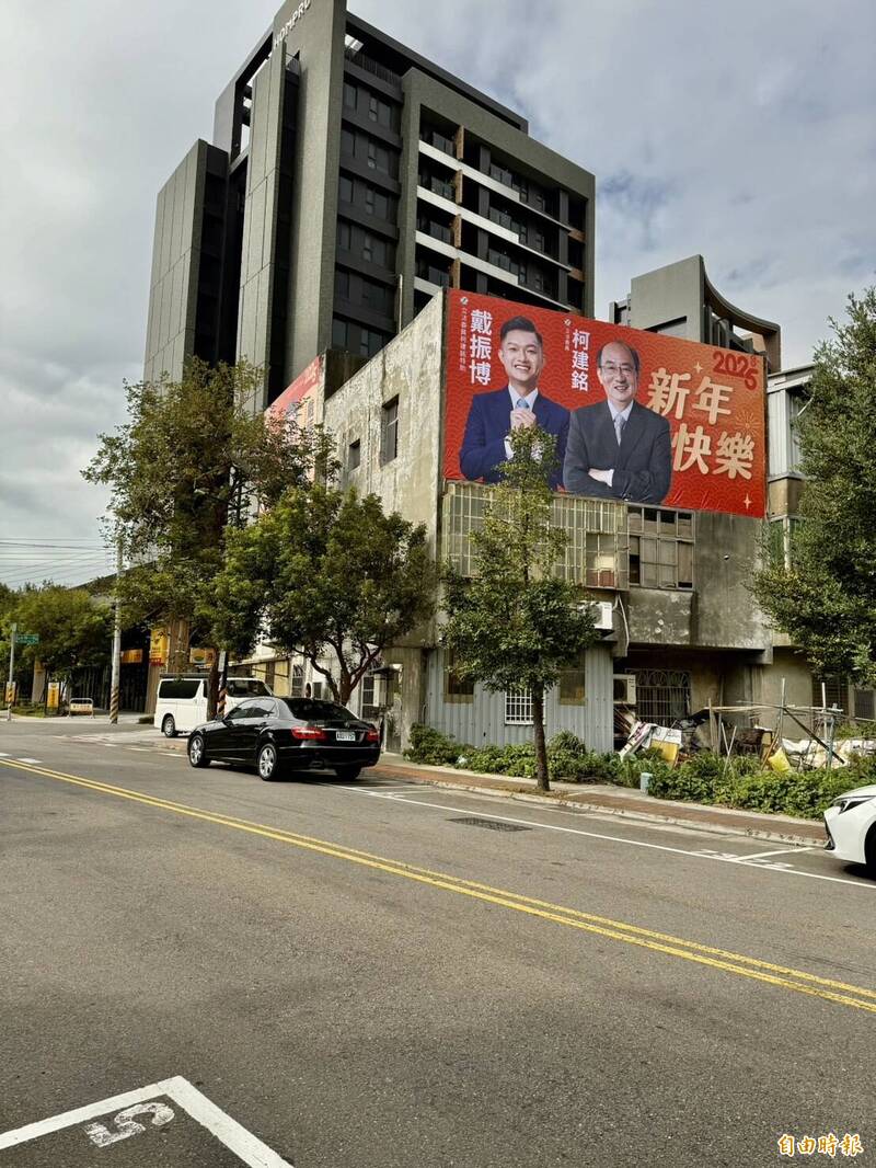 民進黨立院總召柯建銘的助理戴振博，今天起在新竹市街頭，掛上與柯建銘合體的新春賀年看板。（記者洪美秀攝）