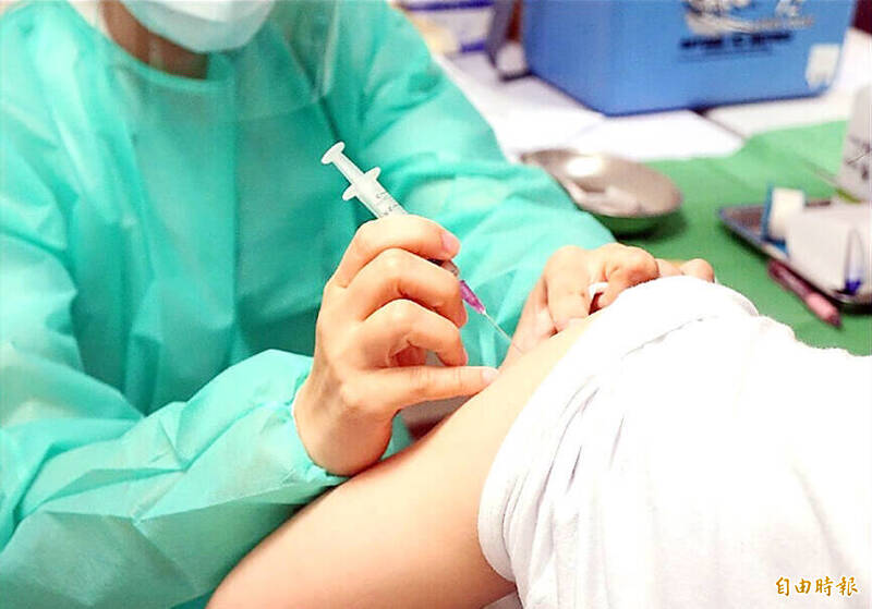 A medical worker administers a vaccine in an undated photograph.
Photo: Taipei Times