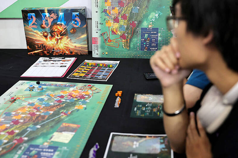 
Players test 2045, a new board game by Mizo Games set against the backdrop of armed conflicts around Taiwan in Taipei on Sept. 22.
Photo: Ann Wang, Reuters