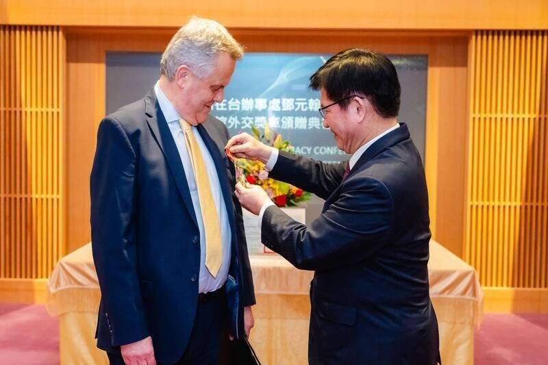 Minister of Foreign Affairs Lin Chia-lung, right, confers a Friendship Medal of Diplomacy to outgoing UK Representative to Taiwan John Dennis in Taipei on Friday last week.
Photo courtesy of the Ministry of Foreign Affairs Minister of Foreign Affairs Lin Chia-lung, right, confers a Friendship Medal of Diplomacy to outgoing UK Representative to Taiwan John Dennis in Taipei on Friday last week.
Photo courtesy of the Ministry of Foreign Affairs