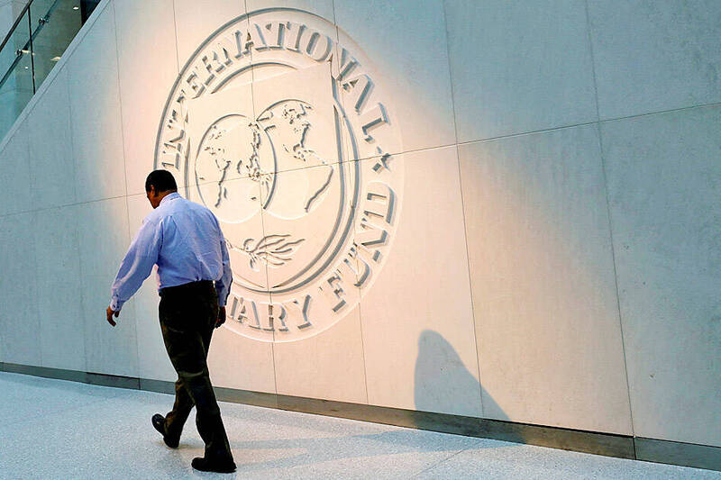 A man walks past the IMF logo at its headquarters in Washington on May 10, 2018.
Photo: Reuters A man walks past the IMF logo at its headquarters in Washington on May 10, 2018.
Photo: Reuters