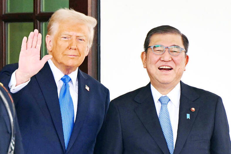 
US President Donald Trump, left, waves as he greets Japanese Prime Minister Shigeru Ishiba outside the White House in Washington on Friday.
Photo: AFP