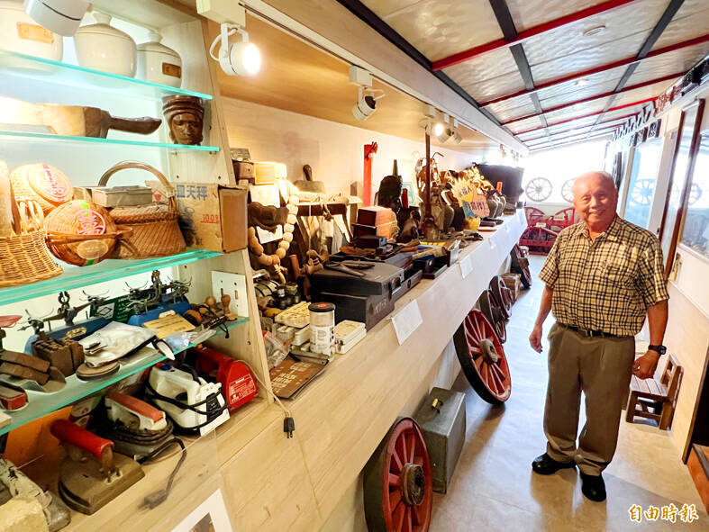 
Early childhood education expert Shen Ming-hsien is pictured with his collections in Tainan on March 1. 
Photo: Wang Chun-chung, Taipei Times