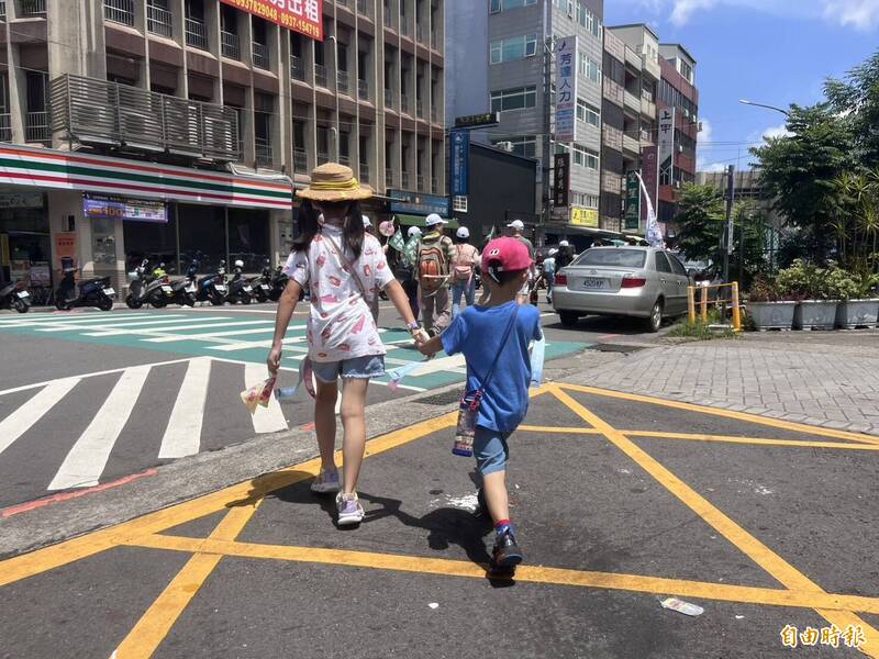 「護國大遶境」新竹縣場有不少親子家庭,其中有一對小姊弟也不畏酷熱跟著家人參加。(記者廖雪茹攝) 「護國大遶境」新竹縣場有不少親子家庭,其中有一對小姊弟也不畏酷熱跟著家人參加。(記者廖雪茹攝)