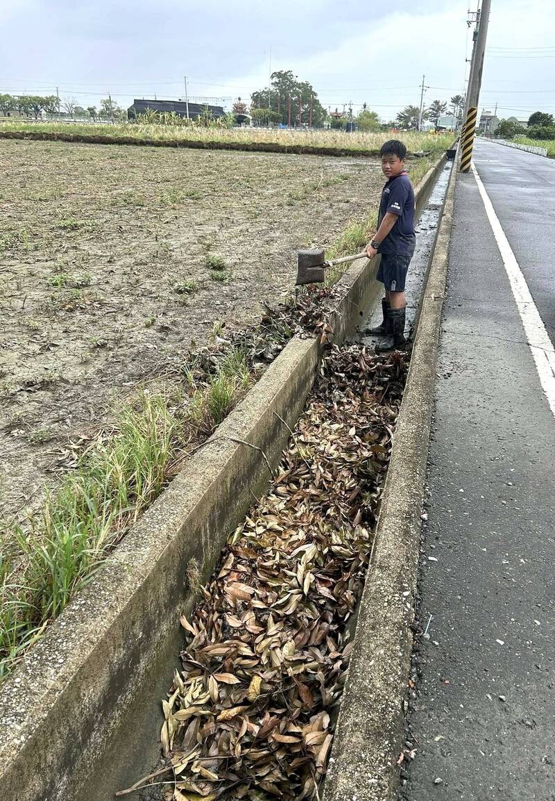 吳姓國中生見到農田水溝內都是落葉,怕下雨造成積水,拿圓鍬清理水溝內的落葉。(取自我是西港人臉書社團) 吳姓國中生見到農田水溝內都是落葉,怕下雨造成積水,拿圓鍬清理水溝內的落葉。(取自我是西港人臉書社團)