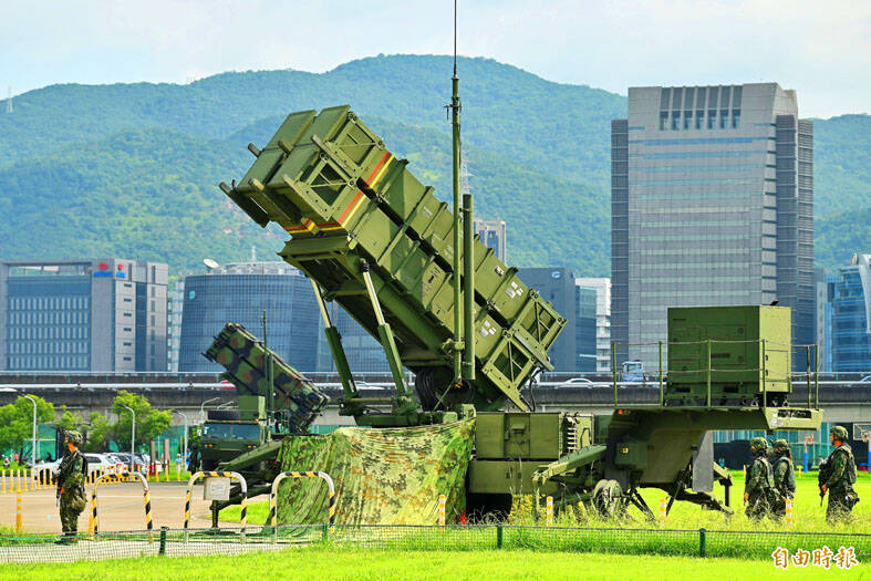 
Troops guard a Patriot missile launcher at a riverside park in Taipei on July 13. 
Photo: Chen Yi-kuan, Taipei Times