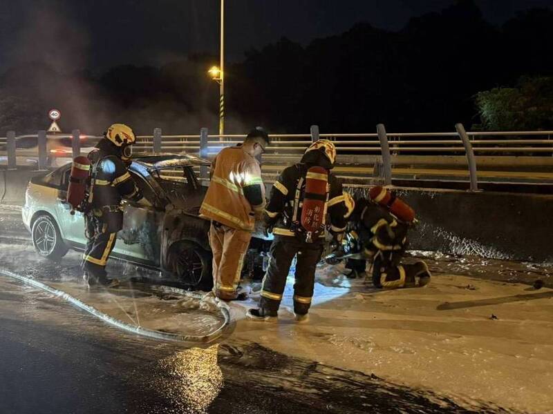 整輛轎車燒成廢鐵，消防員處理殘火。（圖由警方提供）