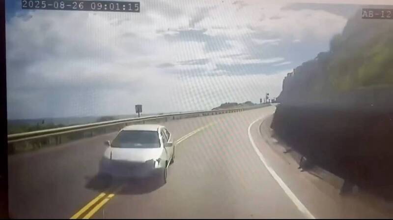 林姓女子今天上午駕車行經台2線75.3公里時，與對向、張簡男子駕駛的砂石車發生對撞，致張簡閃避不及，衝破護欄後，墜入外海岸邊坡，被壓在車底當場死亡，林女為整起肇事主因。（記者林嘉東翻攝）