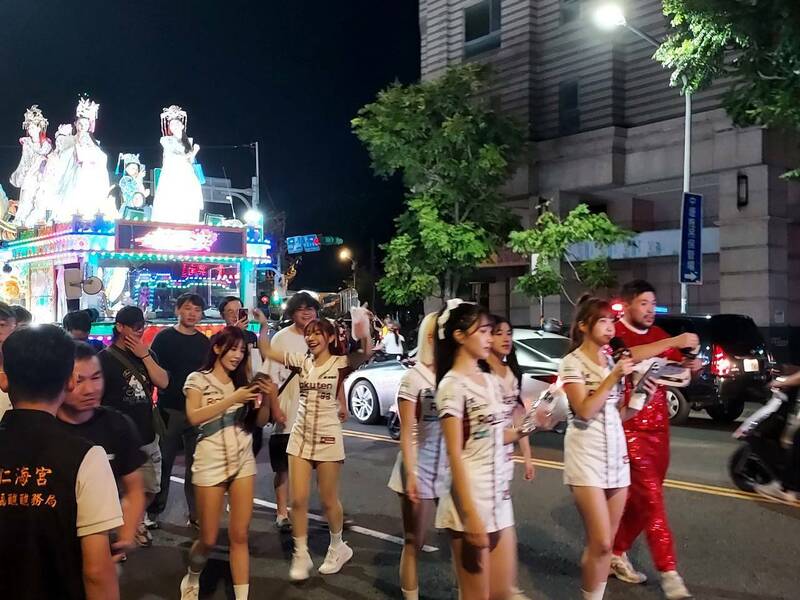 樂天女孩啦啦隊、新明國中青少棒球員加入水燈排的遶境踩街。（中壢區公所提供）