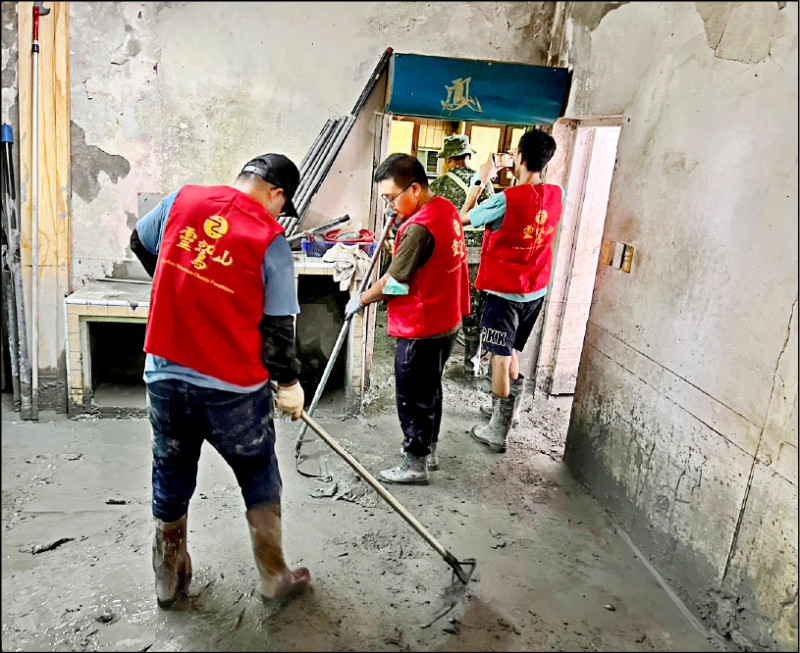 靈鷲山志工協助災民清理家戶內污泥。（靈鷲山提供）