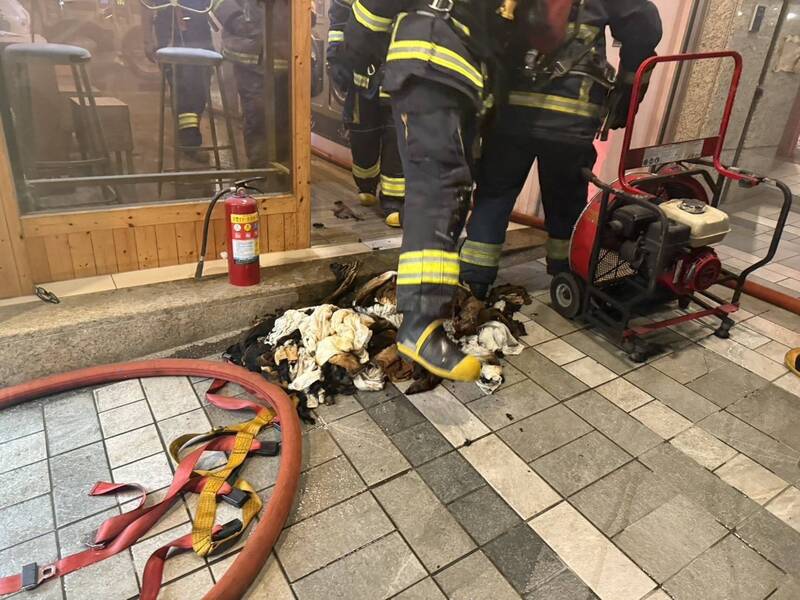 消防人员拿出烘衣机里的毛巾与衣物。（记者徐圣伦翻摄）