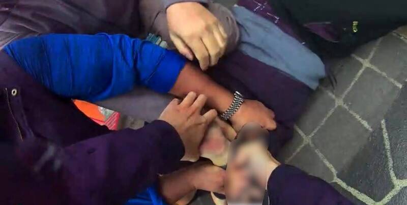 邱男被警方制伏在地，並上銬逮捕。（資料照）
