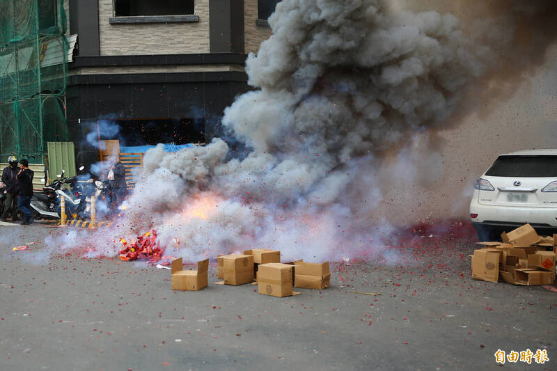 「鞭炮陣」整路狂炸，一旁白車休旅車未移車，導致整台車輛陷入炮陣中。（記者李惠洲攝）