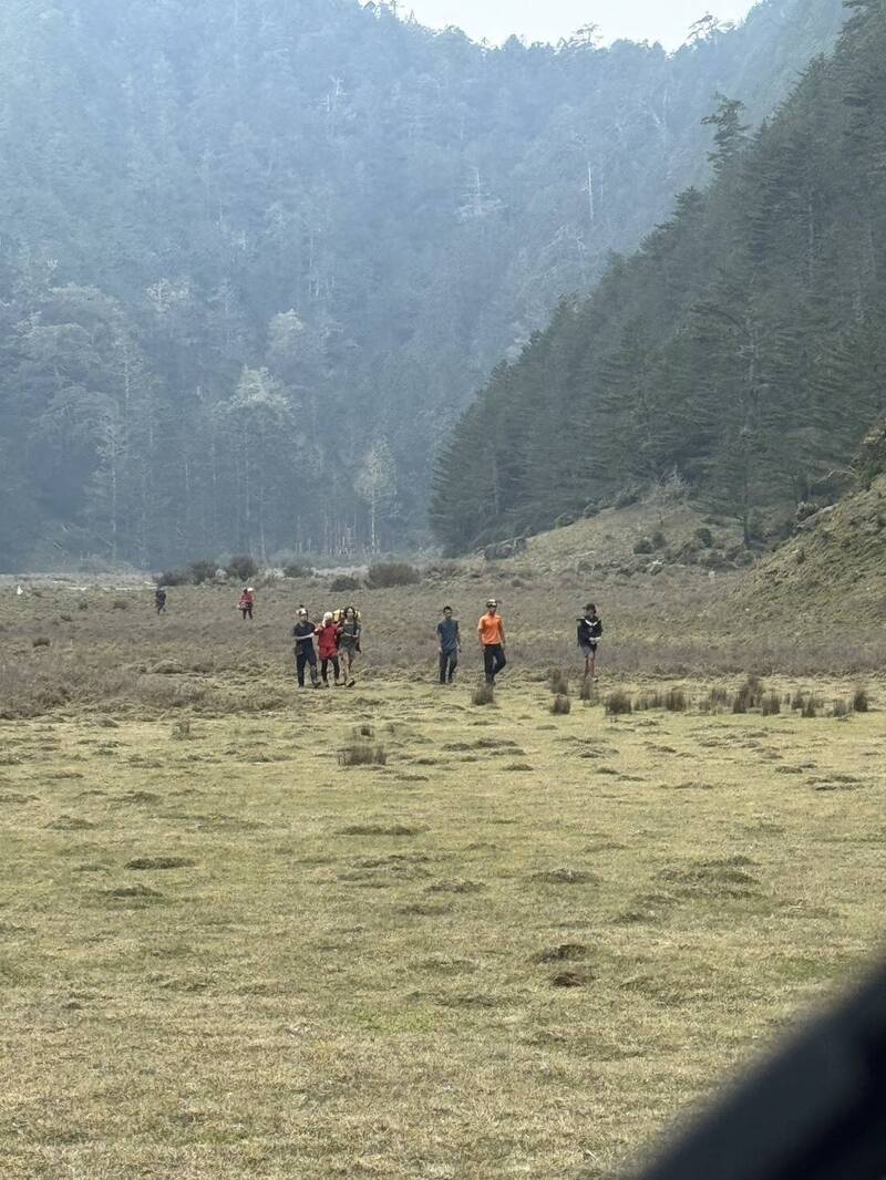 黄姓协作在救难人员搀扶下，在太平谷营地准备登上直升机。（空勤总队提供）