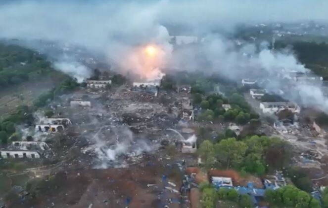 空拍曝光現場慘烈畫面，爆炸地點無一棟完整建築，今日仍不斷爆炸聲及濃煙竄出。（圖擷自央視）