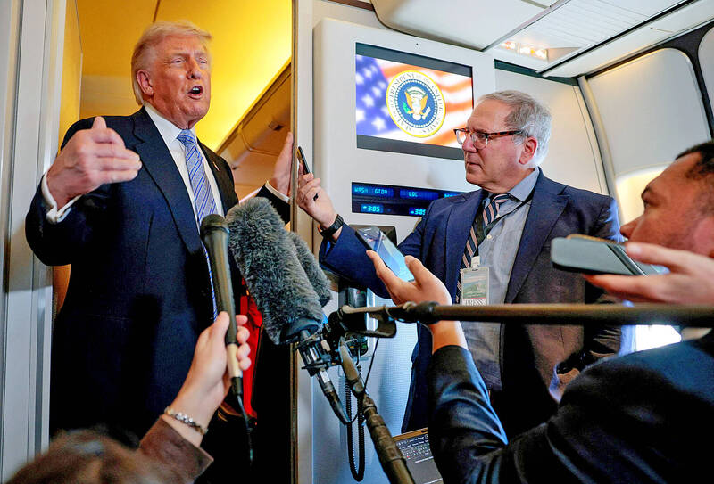 US President Donald Trump speaks to reporters aboard Air Force One en route to the US following his meeting with Chinese President Xi Jinping in China on Friday.
Photo: Reuters